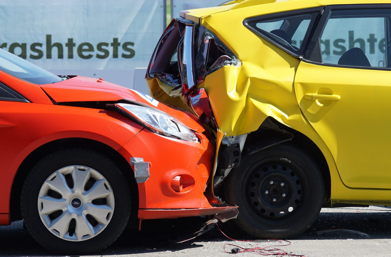 Red car crashed into the rear of a yellow car showing collision damage covered by car insurance
