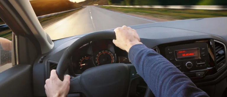 Driver's view from behind the steering wheel while driving on a highway
