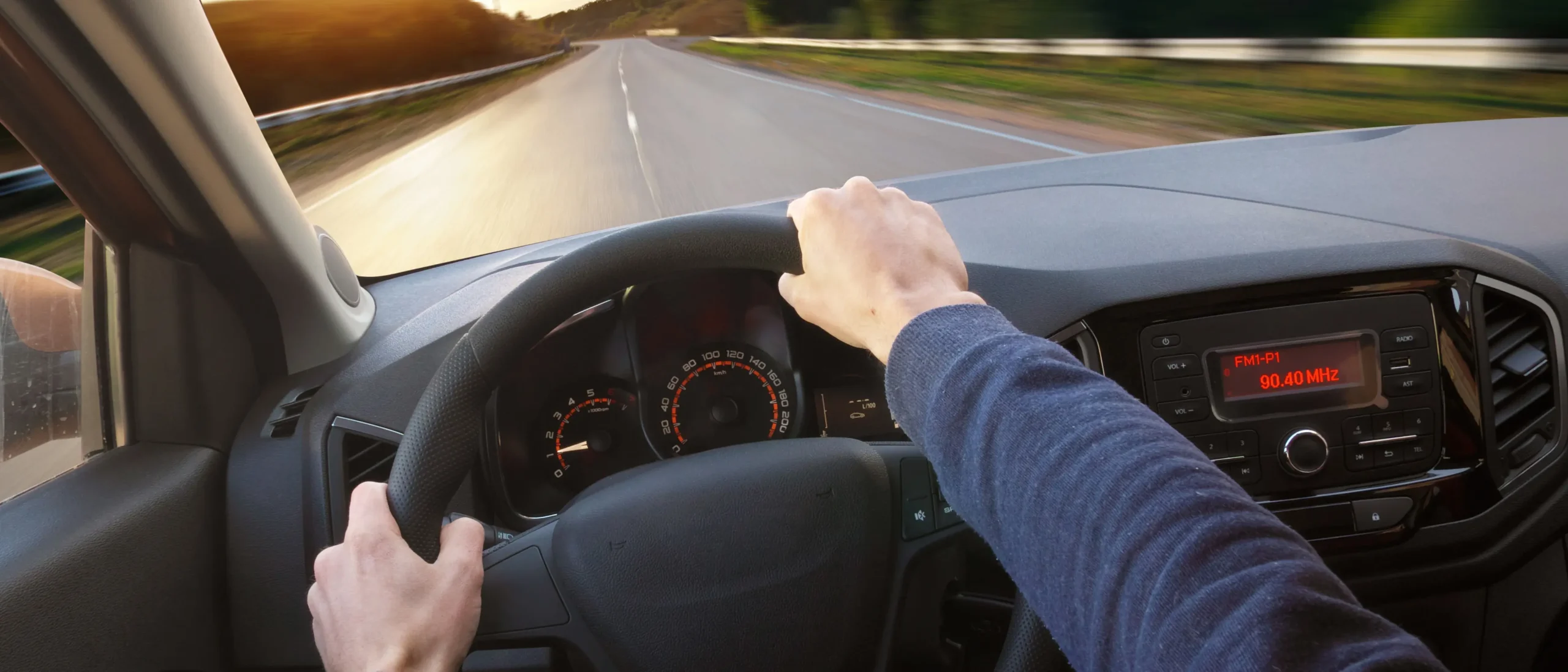 Driver's view from behind the steering wheel while driving on a highway