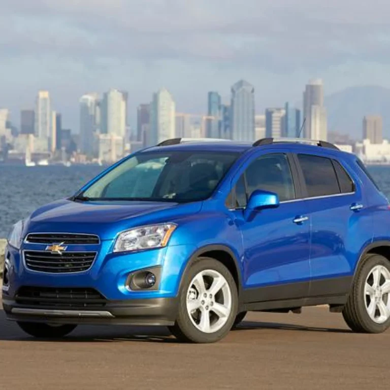 blue Chevrolet Trax SUV parked by a city waterfront