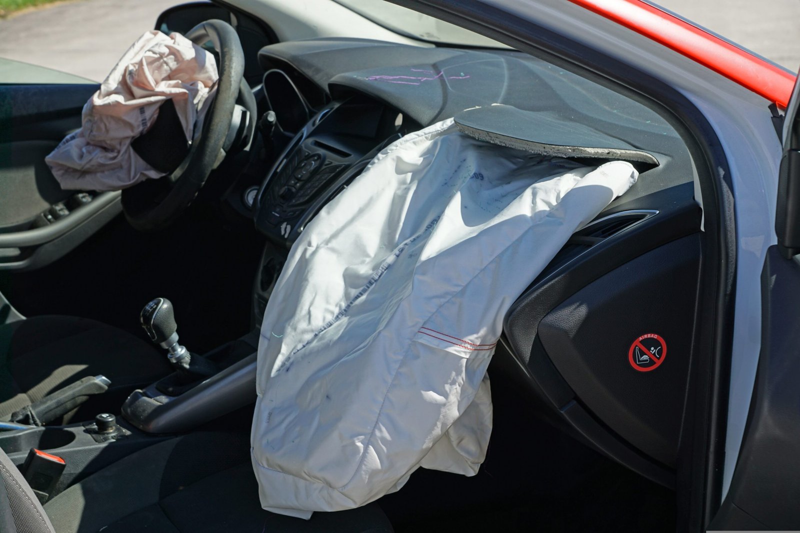 deployed airbag and dashboard damage after a car collision